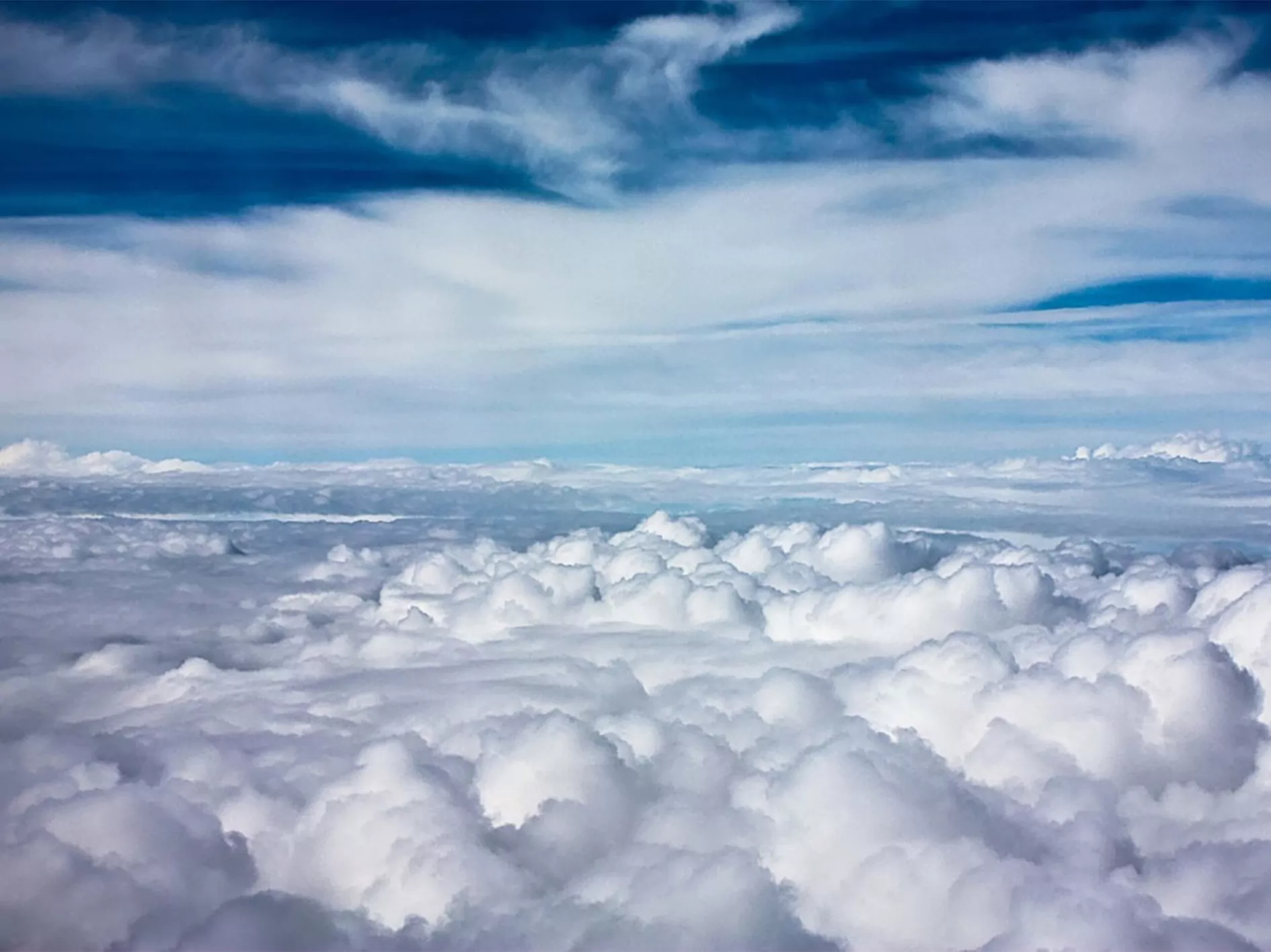 Why is the Earth’s surface warmed up better than at the height of clouds?